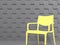 Trendy colors of the year 2021 Illuminating and Ultimate gray. Yellow designer chair against background of volumetric gray wall