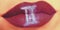 Trendy Creative lip makeup. Closeup Shiny glossy lips with Gemin