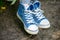 Trendy denim sneakers with white laces close-up  on natural background