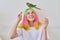 Trendy fashionable with colored hairstyle teenager with green parrot on head