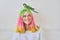 Trendy fashionable with colored hairstyle teenager with green parrot on head