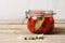 Trendy Fermented vegetables. Red Ripe Cherry Tomatoes in glass jar, selective focus.