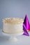 Trendy festive colorful cake on cake stand over light background.