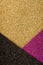 Trendy festive glitter background in golden, black and purple pink colours with copy space. Minimal fashionable style