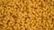 Trendy flat view closeup falling yellow macaroni. Top view, flat lay. Nature concept. Texture background, pattern.