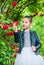 Trendy girl fancy dress and leather jacket in roses garden, cool child concept