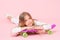Trendy girl. Girl likes to ride skateboard. Active lifestyle. Girl having fun with penny board pink background. Kid