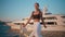 Trendy girl posing waterfront looking camera. Luxurious woman standing pier.