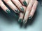 Trendy green manicure on a textural