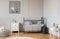 Trendy grey baby room design in tenement house, copy space on empty wall