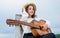 trendy looking kid girl play acoustic guitar, singer