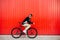 Trendy man sitting on bike, looking back, on the street