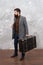 Trendy man with travel suitcase. Vintage trip bagage. Modern life. Male fashion model. Mature businessman with beard