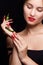 Trendy manicure and red lips with green chili pepper.