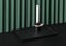 Trendy metal black tray with dark candlestick on folded green wall background