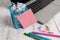 Trendy metallic laptop sticky note pad waste basket crushed paper pens lying wooden rustic vintage table. Personal