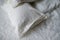 Trendy organic natural linen bedclothes with wooden buttons closeup