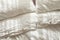 Trendy organic natural linen bedclothes with wooden buttons closeup. Bedding