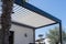 Trendy outdoor patio pergola shade structure, awning and patio roof, garden lounge and chairs