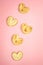 Trendy pink pastel background with five heart shape cookies. Holiday pastries for Valentine`s day or Women`s day.