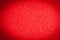 Trendy red surface for background and wallpaper with dark vignetting gradient