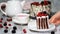 Trendy rustic vertical roll high cake with chocolate, vanilla cream and berries.