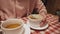 Trendy student girl enjoys apple-pumpkin pudding and drinks her with herbal detox tea.