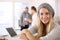 Trendy student smiling at office desk