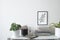 Trendy and stylish interior of living room with mock up poster frame ,plants and vintage accessories on the wooden shelf. White