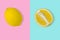 Trendy summer idea with yellow lemon slice and whole fresh lemon on bright pink and blue background