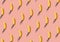 Trendy sunlight Summer pattern made with fresh banana fruit on bright light pink background. Minimal summer concept