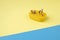 Trendy sunlight Summer scene made with miniature people on bright light blue and yellow background