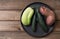 Trendy ugly organic natural potato,cucumber and squash on the black plate, on natural wooden background. Copy space