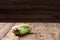 Trendy ugly organic squash on natural wooden table on dark blurred background. Copy space