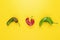 Trendy Ugly red chilli peppers on yellow background, minimal nature style, pop-art, creative food concept