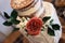 Trendy wedding cake with edible rose floral arrangement. Cake features a naked top tier with a knitted design bottom tier
