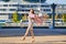 Trendy woman in striped dress throws open lilac coat