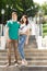 Trendy young couple posing on a flight of stairs