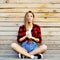 Trendy young woman posing against wooden wall