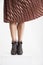 Trendy young woman`s legs flitting skirt.