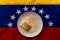 Tres leches cake on top of venezuelan flag, a traditional venezuelan dessert with milk and cinnamon powder, symbol of latin