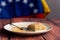 `tres leches` cake on wood table with venezuelan flag in background, a  traditional latino dessert with milk and cinnamon powde