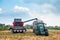 Treviso, Italy - 20 september 2019: combine harvester unload corn in tractor  field in italian countryside, symbol agriculture and