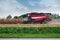 Treviso, Italy - 20 september 2019: combine harvester unload corn in tractor  field in italian countryside, symbol agriculture and