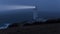 Trevose Head Lighthouse in Cornwall after dark in the fog.