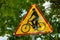 Triangle bicycle sign transit prohibited for bicycles on blurred park background. Bicyle road sign, prohibition yellow