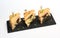 Triangle club sandwich tripple set on black ceramic plate against white background