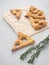 Triangle cookies with rosemary. Vertical. High view.