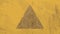 Triangle design against textured yellow background