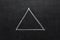 Triangle drawn with chalk on blackboard